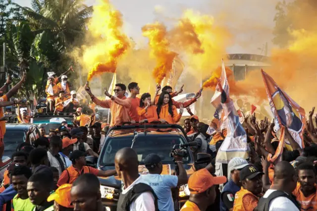 Madagascar President Andry Rajoelina, candidate in the 2023 presidential election, his wife Mialy Rajoelina and their three children, ride in a pickup truck to greet supporters during his re-election campaign, in Toamasina, November 11, 2023