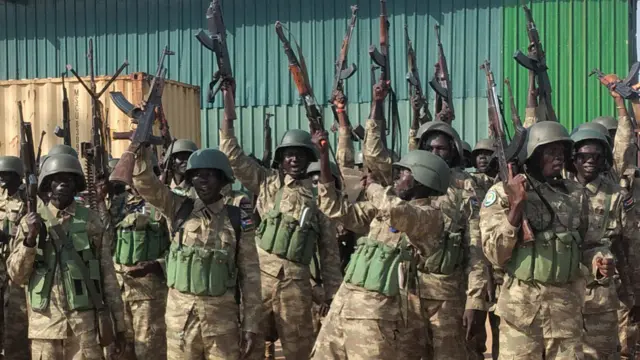 Soldiers raising weapons in celebration