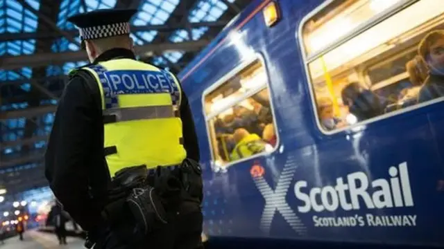 Police officer by a train