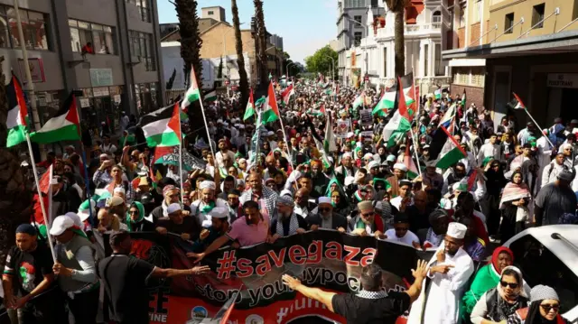 Demonstrators protest in support of Palestinians as they march to Parliament in Cape Town