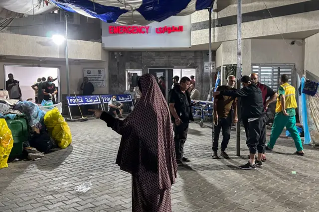 People stand outside the emergency ward of Al-Shifa hospital in Gaza City on November 10, 2023