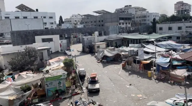 Tents and shelters used by displaced Palestinians stand at the yard of Al Shifa hospital