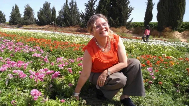 Yehudit Weiss pictured in a field of flowers