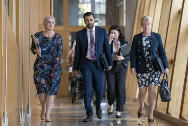 Shona Robison, Humza Yousaf and Angela Constance make their way to the chamber