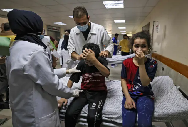 A group of people crying inside al-Shifa hospital