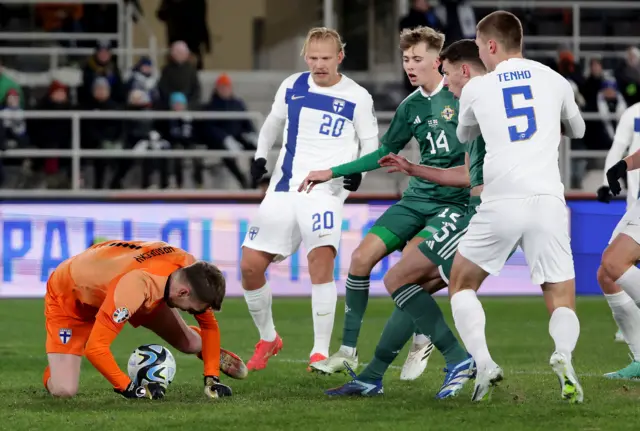 Northern Irelands Isaac Price with Finlands Lukas Hradecky