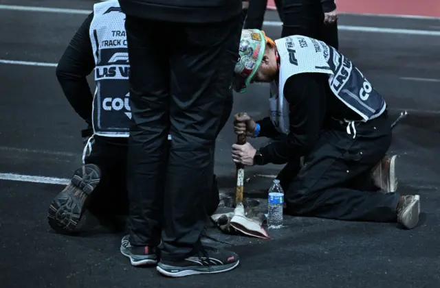 Engineers fix a loose drain cover on the Las Vegas track