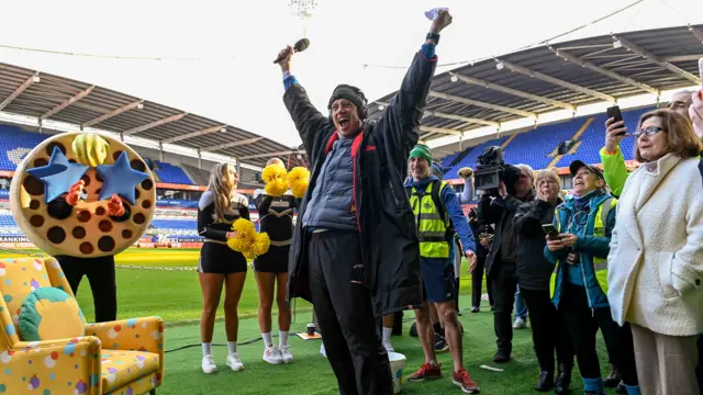 Vernon cheers, surrounded by supporters and his Mum