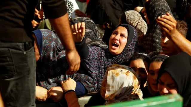 A woman yells at a man standing above the crowd