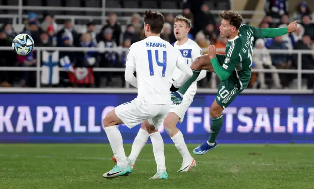 Northern Ireland's Dion Charles with Finland's Kaan Kairinen