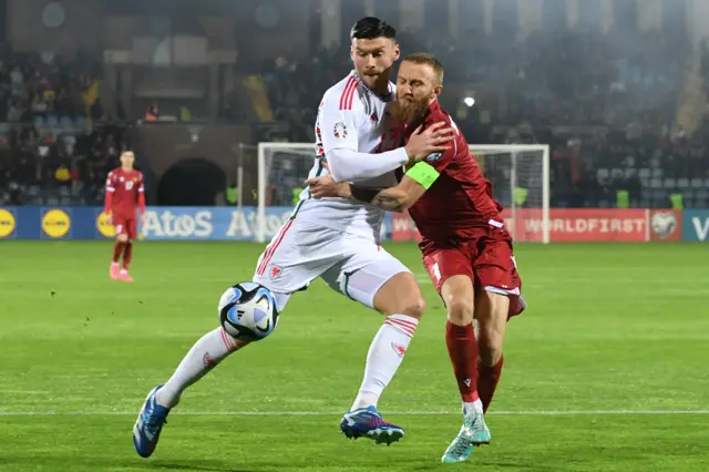 Wales forward Kieffer Moore fights for the ball with Armenia defender Varazdat Haroyan