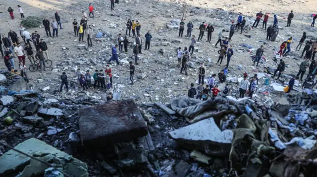 A view from above of people surveying wreckage