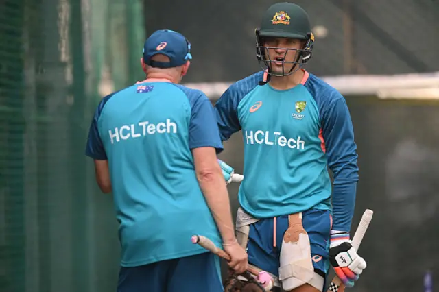 Alex Carey of Australia speaks with coaching staff