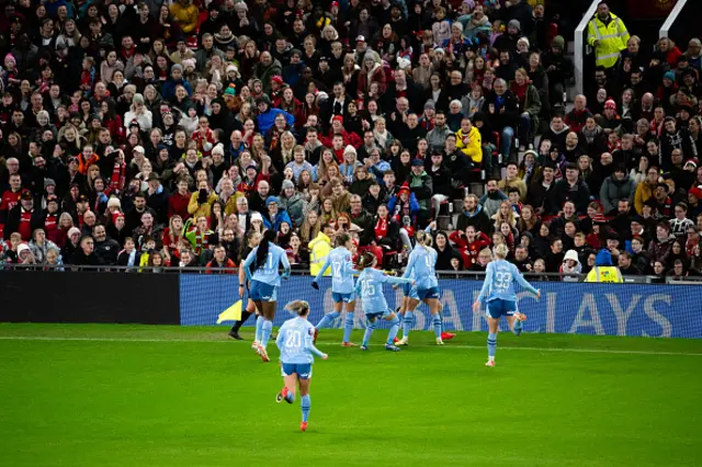 Manchester City players celebrate in front of the Man United fans