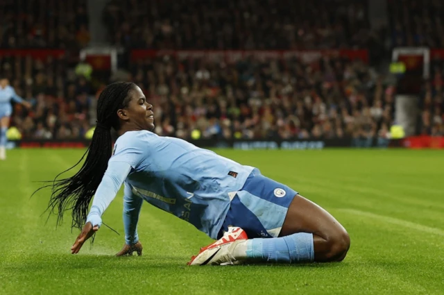 Khadija Shaw slides on her knees after scoring