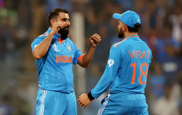 Mohammed Shami of India celebrates with teammate Virat Kohli after dismissing Rachin Ravindra of New Zealand (not pictured) during the ICC Men's Cricket World Cup India 2023 Semi Final match between India and New Zealand at Wankhede Stadium on November 15, 2023 in Mumbai, India.