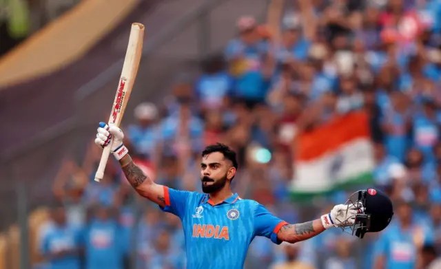 Virat Kohli of India celebrates after scoring a century, overtaking Sachin Tendulkar for the all time most ODI centuries during the ICC Men's Cricket World Cup India 2023 Semi Final match between India and New Zealand at Wankhede Stadium on November 15, 2023 in Mumbai, India.