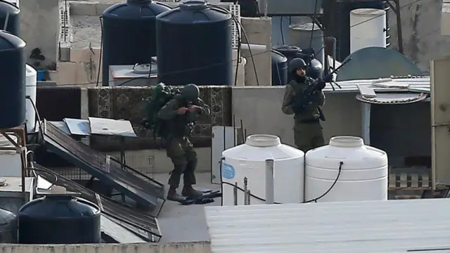 Two IDF soldiers on a roof