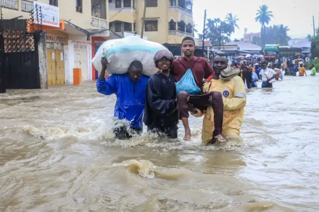 People wading through a flooded street in Mombasa, Kenya- 17 November