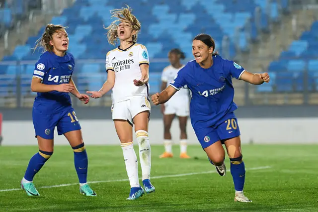 Sam Kerr celebrating a goal with her arms aloft