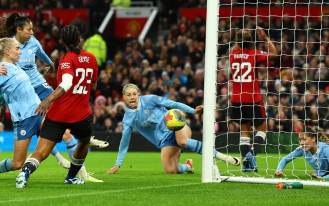 Geyse prods the ball into the net as City players look on