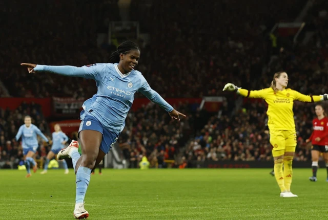 Shaw runs off to celebrate with Mary Earps in the background