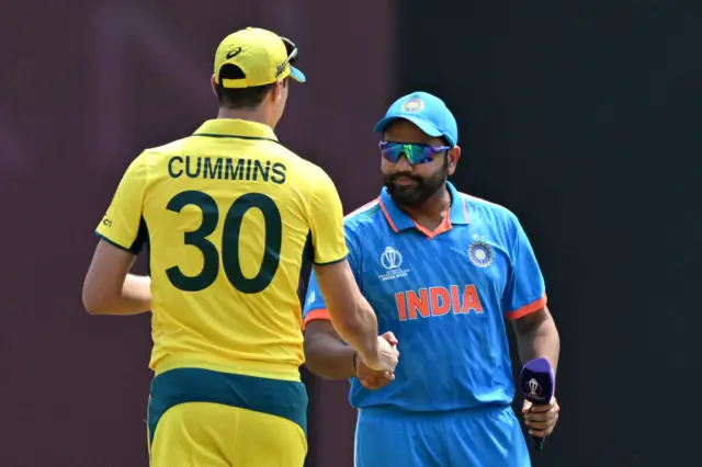 Australia's captain Pat Cummins (L) and India's captain Rohit Sharma shake hands after the toss at the start of 2023 ICC Men's Cricket World Cup one-day international (ODI) match between India and Australia at the MA Chidambaram Stadium in Chennai on October 8, 2023.