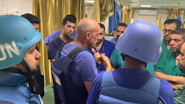 A UN team speaks to medical staff inside a hospital