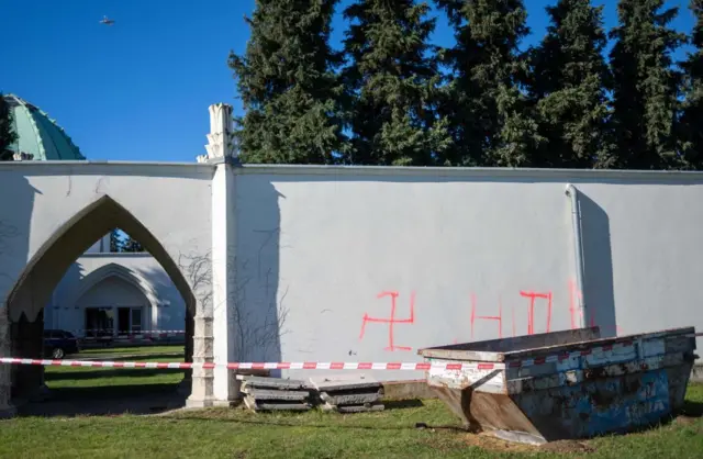 swastika symbols sprayed on an external wall in front of the ceremony hall at the Jewish part of the Central Cemetery in Vienna, Austria