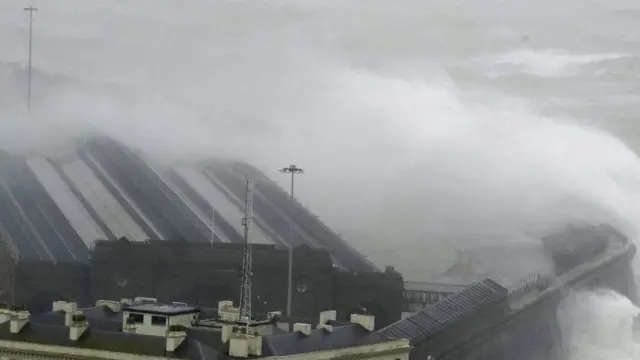 Waves and sea foam against the harbour wall in Folkestone