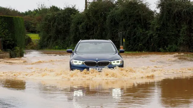 Vehicle driving through a flooded road