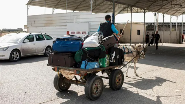 A Palestinian on a donkey-drawn cart waits at the Rafah border crossing