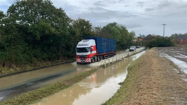 Lorry driver at Winfarthing driving through water