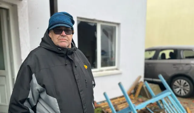 Barry Aubert outside his home in Jersey