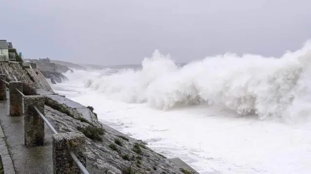 Large waves rolling into the coast in Porthleven, near Cornwall