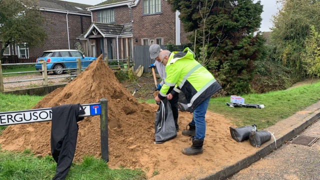 Sandbags being filled on Ferguson Way, Attleborough