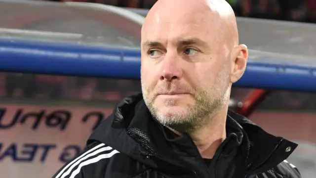 Robert Page coaching Wales from the dugout against Armenia