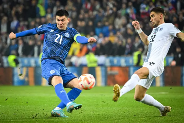 Kazakhstan's Abzal Beysebekov (left) fights for the ball with Slovenia's Adam Cerin in Ljubljana.