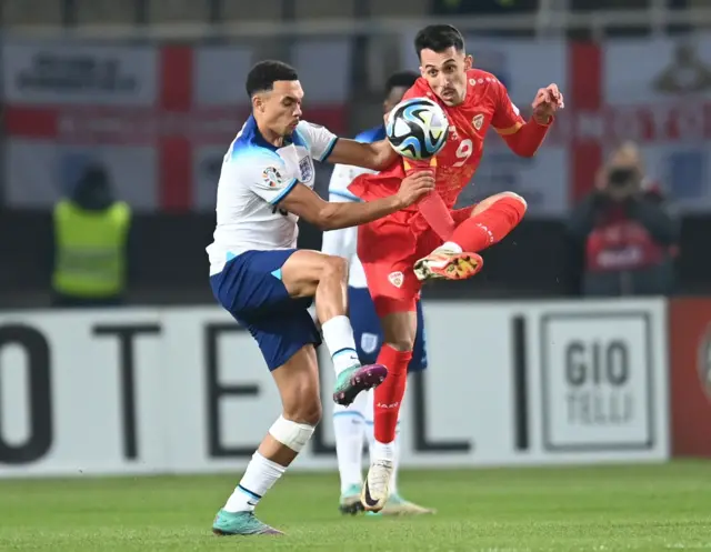 Alexander-Arnold challenges for the ball in midfield.