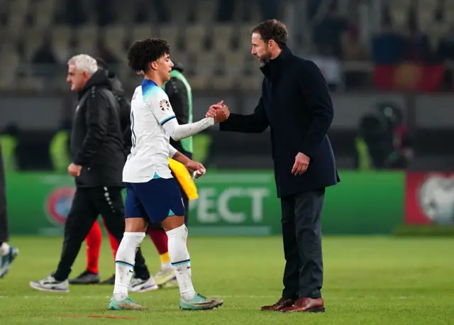 Rico Lewis is greeted with a handshake by Gareth Southgate.