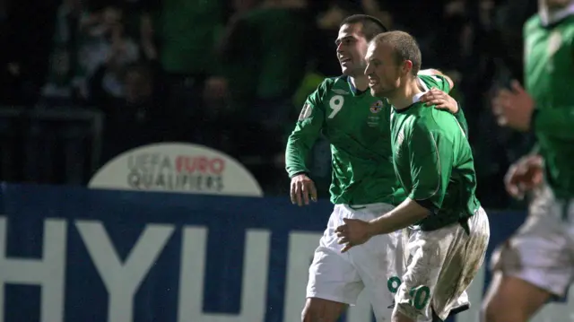 Warren Feeney and David Healy celebrate