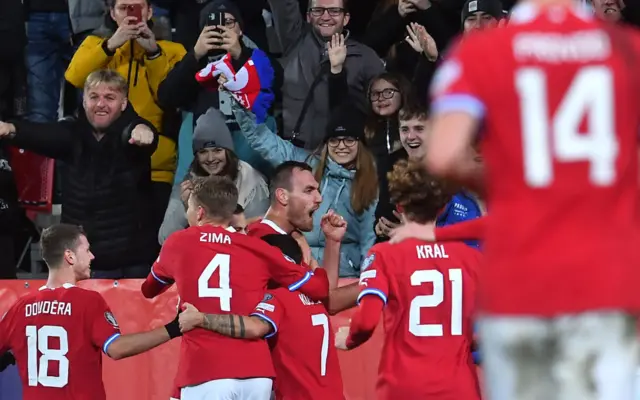 Czech players run to congratulate their teammate after his goal.