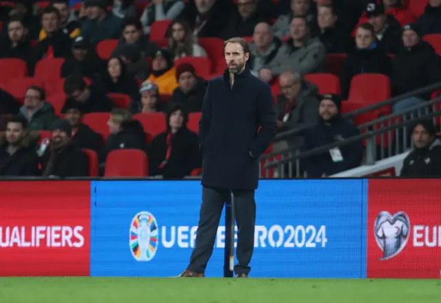 Gareth Southgate stands on the sidelines with his hands in his pockets at Wembley.