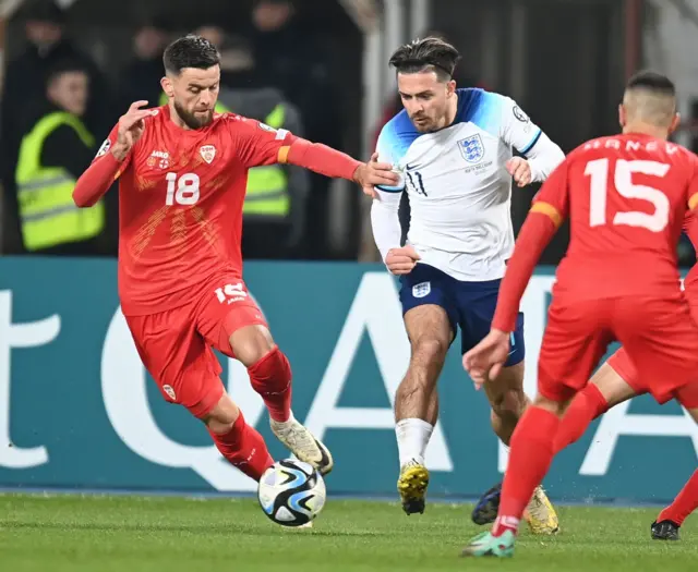 Grealish tries to thread the ball through two defenders on the wing.