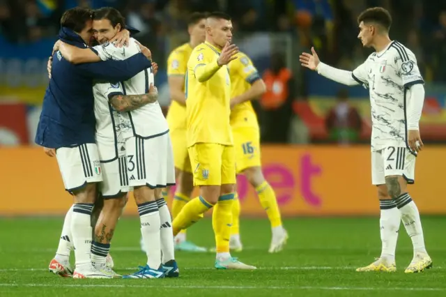 Italy players congratulate each other and shake hands with Ukraine players.