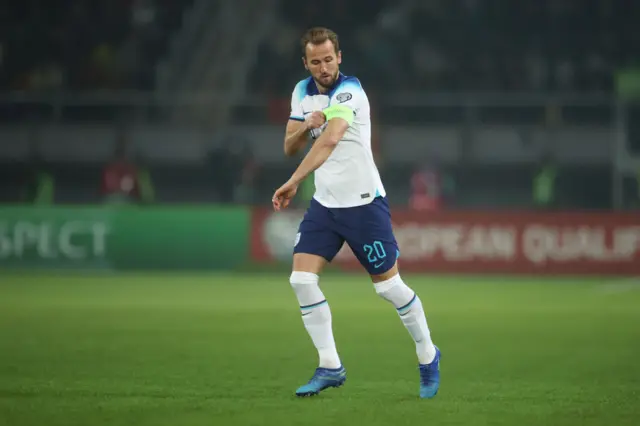 Kane runs onto the field and adjusts his captain's armband as he goes.