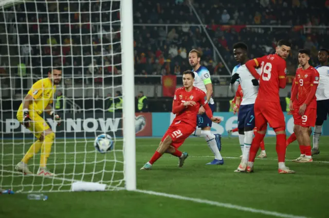 Kane looks on as his diverted header flies into the far corner.