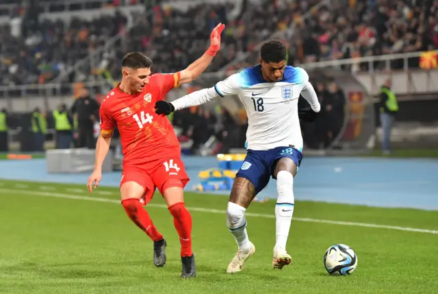 Rashford tries to run past his marker on the wing.