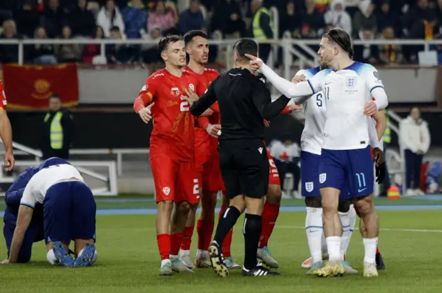 Grealish points angrily after being on the receiving end of a hard challenge,.