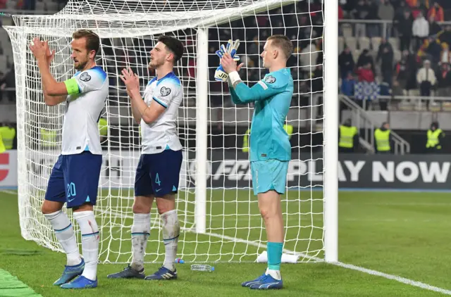 England players applaud the travelling fans.